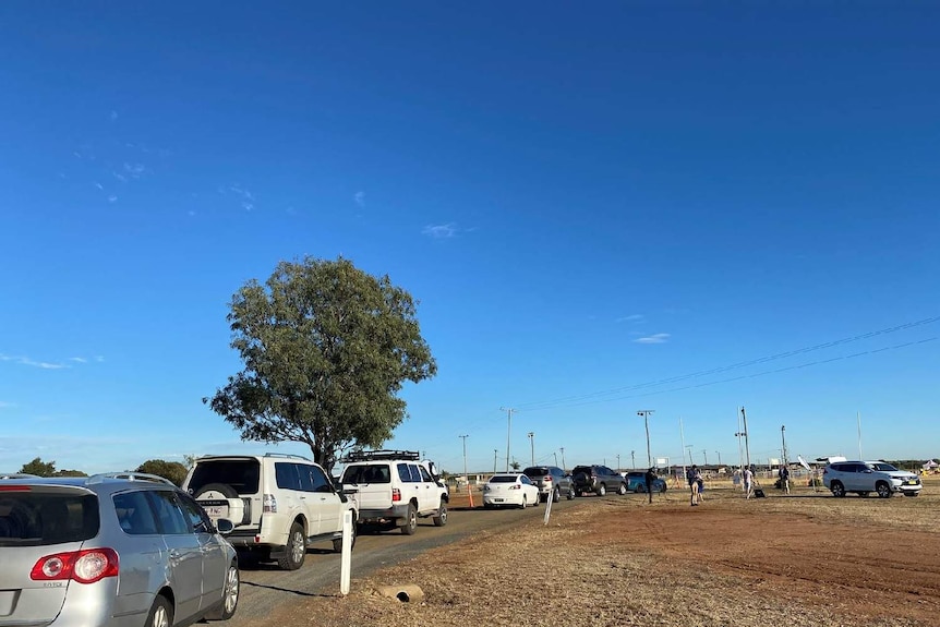 Blackwater locals line up in cars at a fever clinic for COVID-19 testing.