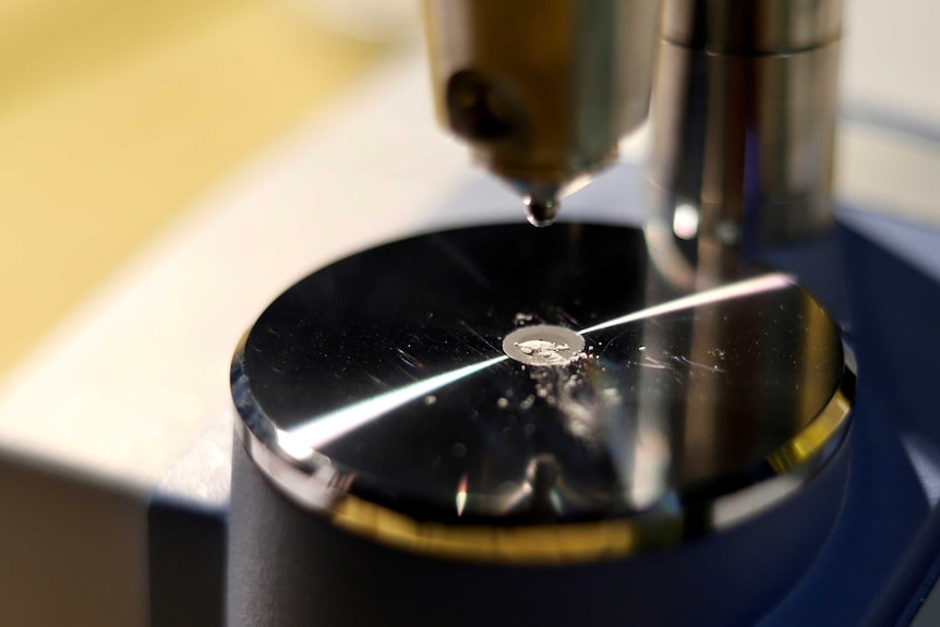 Close up of some pill scrapings being tested by a medical machine.