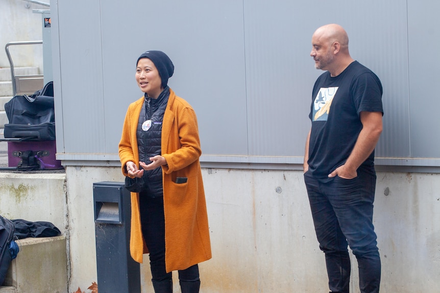 A Chinese-Indonesian woman stands next to a man in a Smoking Ceremony.