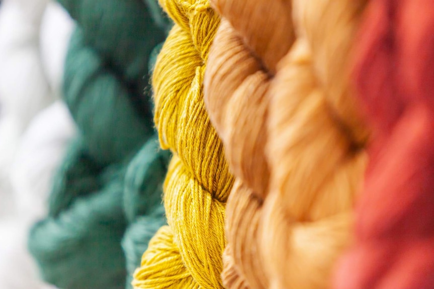 Yarn in twists in different colours including red yellow and green.