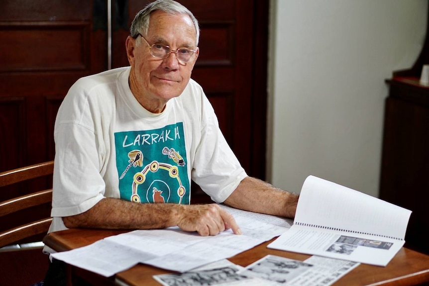 Bill Day looks is sitting at table looking at 1973 genealogy of the Larrakia records.