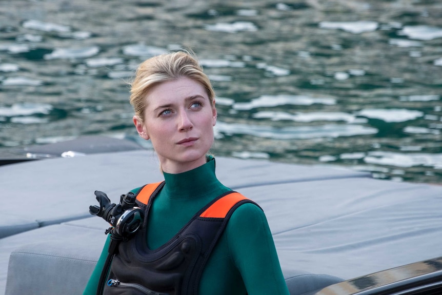 Elizabeth Debicki in scuba gear on a boat in the film Tenet