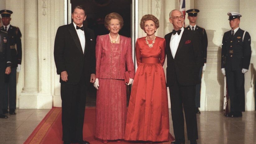 Left to right: Ronald, Margaret, Nancy and Denis. The women both wear red gowns and the men wear suits with bow ties.