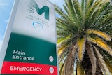 A sign reads 'Mildura Base Public Hospital', beside a palm tree.