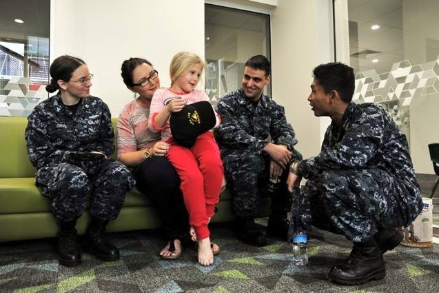 USS George Washington sailors visit with a patient from Mater Children's Hospital in Brisbane