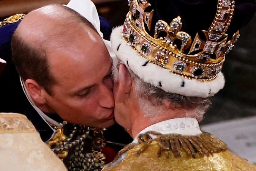 William kisses a crowned Charles on the cheek