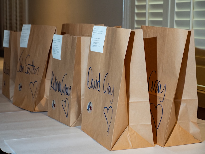 Restaurant takeaway bags on table.