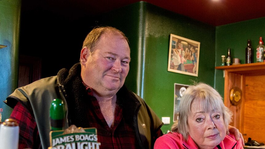 Stuart and Leonie stand behind the bar of their pub in Derby