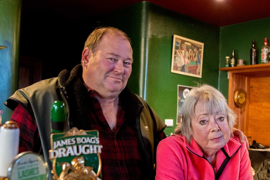 Stuart and Leonie stand behind the bar of their pub in Derby