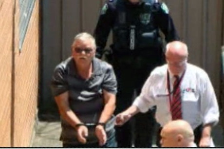 Adrian Mahony in handcuffs