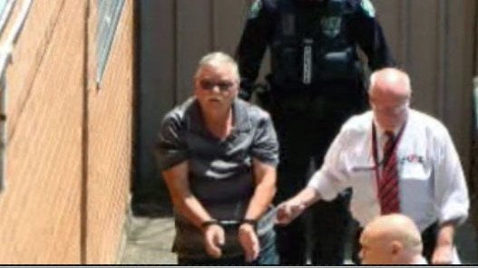 Adrian Mahony in handcuffs