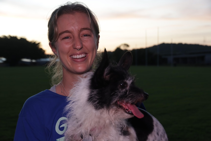Nhulunbuy resident Chloe Hunt smiles at the local footy oval while holding a dog.