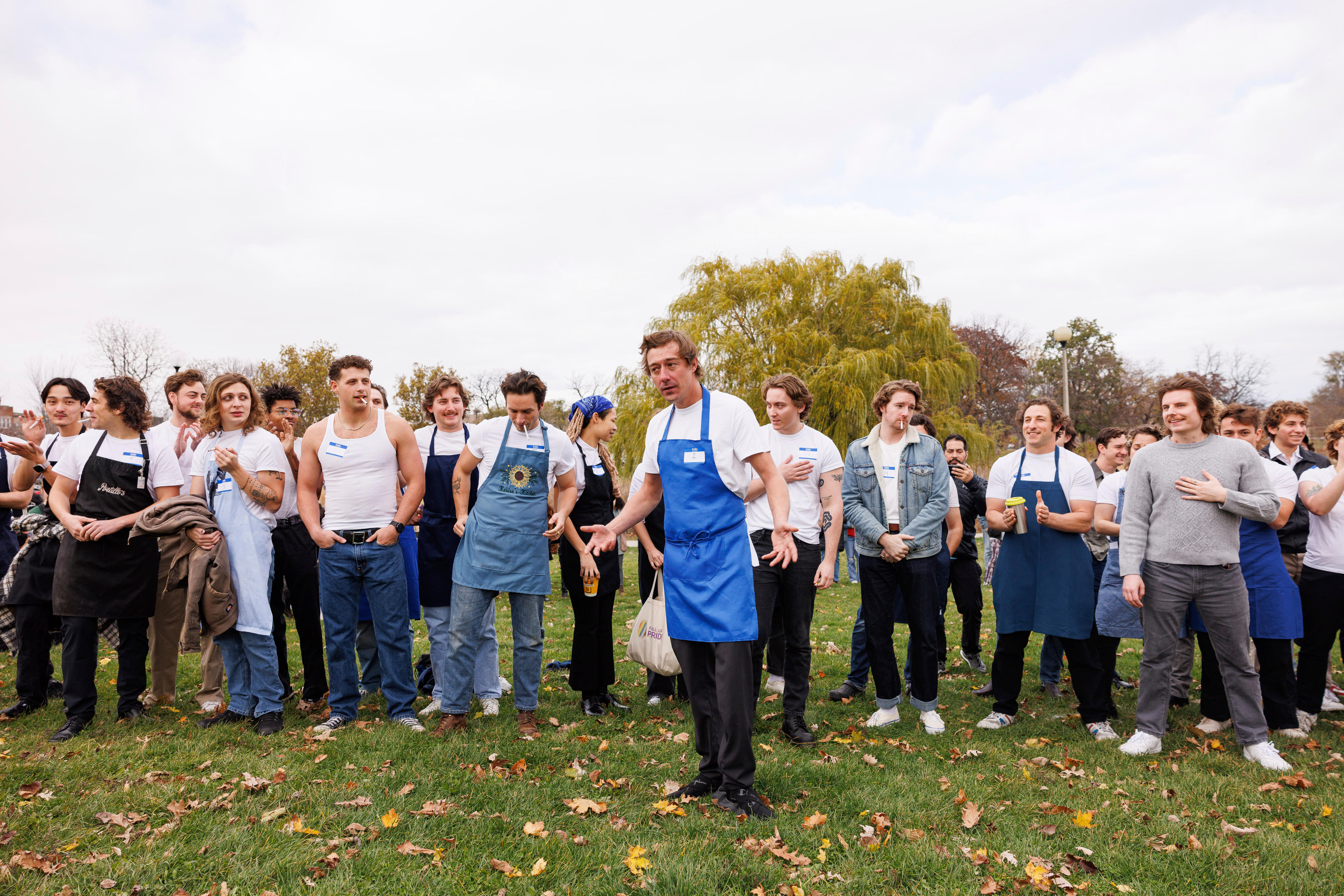 A group of men who look like Jeremy Allen White standing in a line being judged