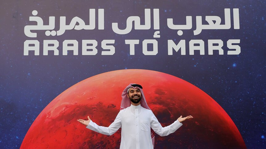 An attendee poses as he arrives to an event to mark Hope Probe's entering the orbit of Mars, in Dubai,