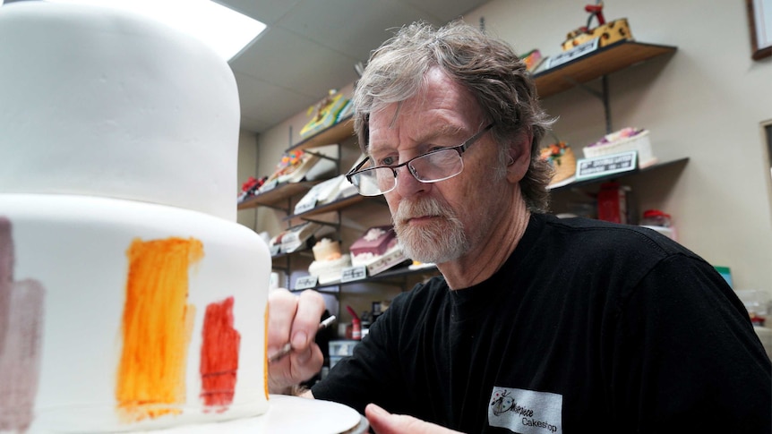 Baker Jack Phillips decorates a cake in his Masterpiece Cakeshop in Lakewood, Colorado