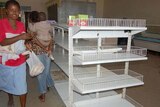 Zimbabwean shoppers walk past empty shelves in a supermarket in Harare.
