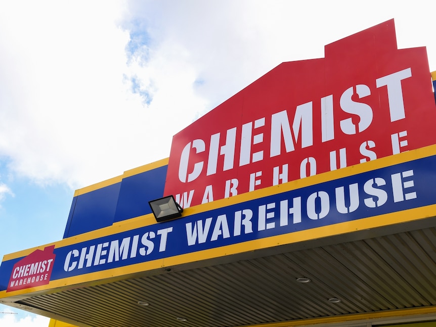 Signage on a shop front with a red house silhouette that reads Chemist Warehouse.