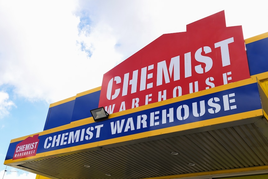 Signage on a shop front with a red house silhouette that reads Chemist Warehouse.