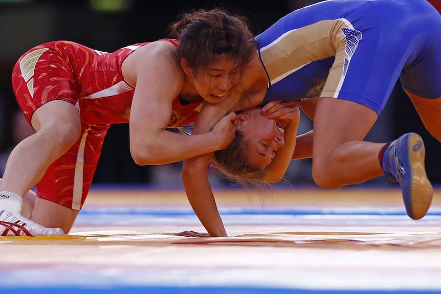 Japan's Saori Yoshida (left) has taken out her third consecutive gold medal in the freestyle wrestling
