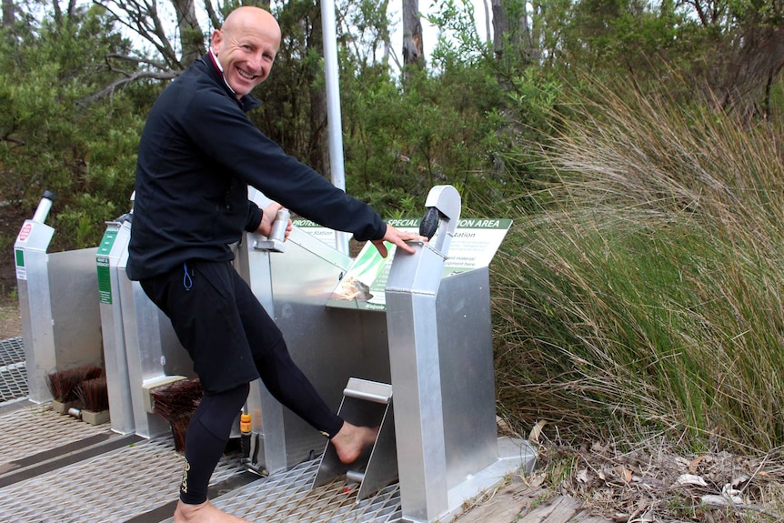 A photo of Walpole eco-warrior Gary Muir using one of the wash-down units.