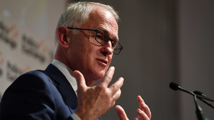 Malcolm Turnbull gestures with both hands while delivering a speech.