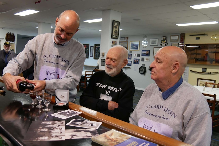 Guy Barnett pours Teddy's old navy buddy Jack Bird and nephew Garry Ivory a drink.