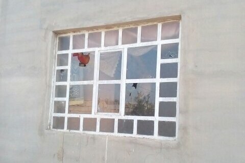 A smashed window at Khalil Ibrahim's home.