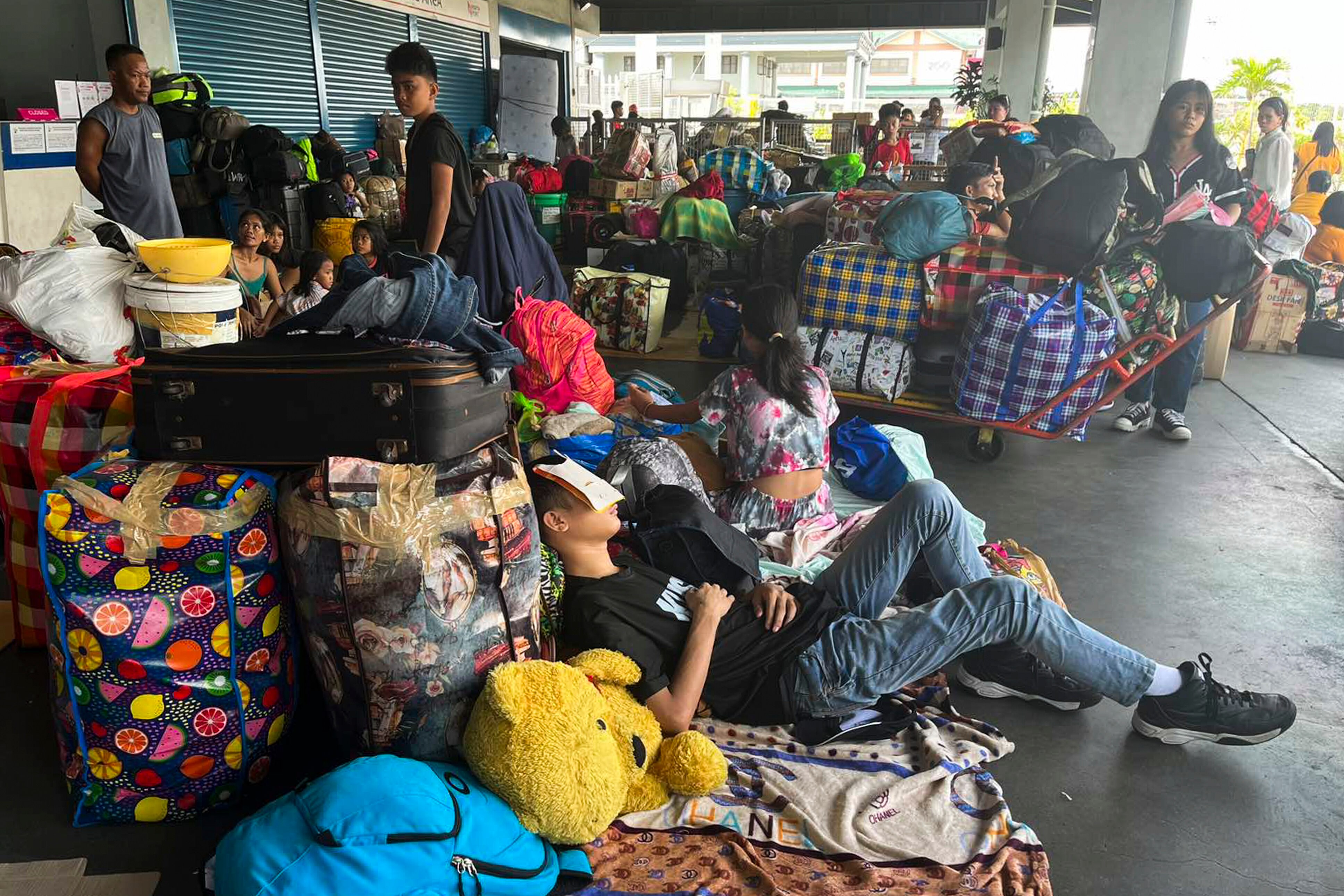 Stranded passengers stay at passenger terminal after sea travel was suspended due to Typhoon Doksuri in Manila.