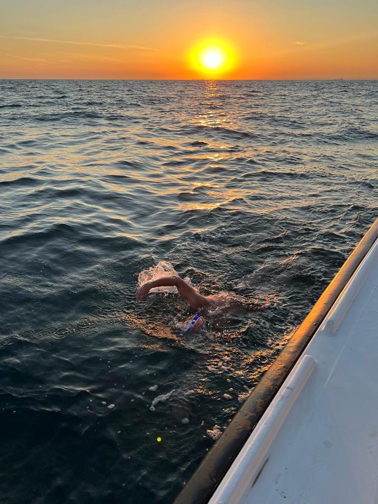 Brendan Cullen swimming alongside a boat in the English Channel. 