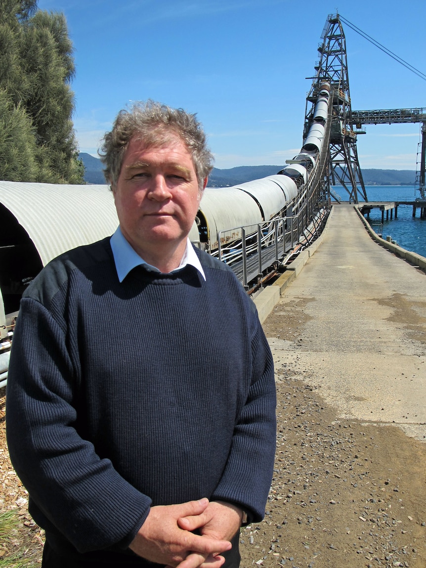 Alec Marr stands in front of the Triabunna woodchip mill on Tasmania's east coast