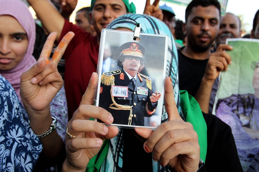 Libyans hold photo of Gaddafi
