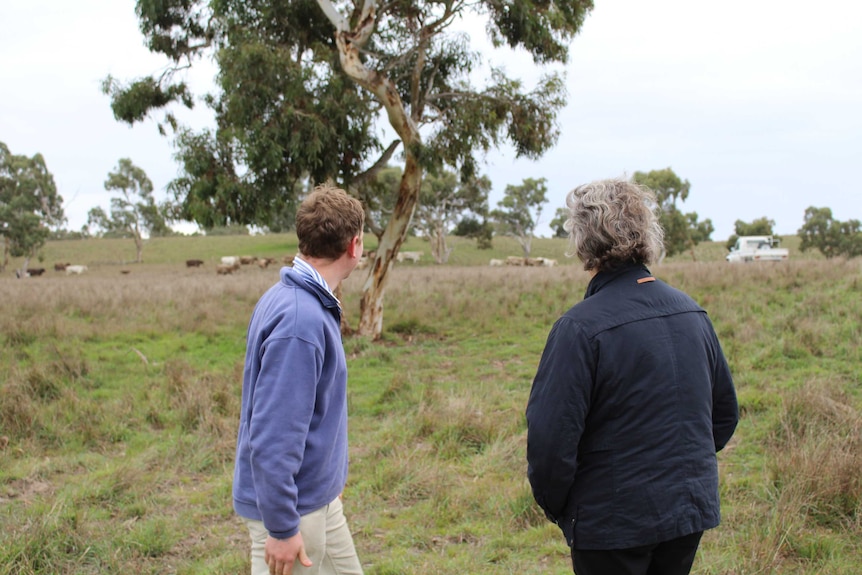 Daniel Lutz and Dr Temple Grandin in a field.