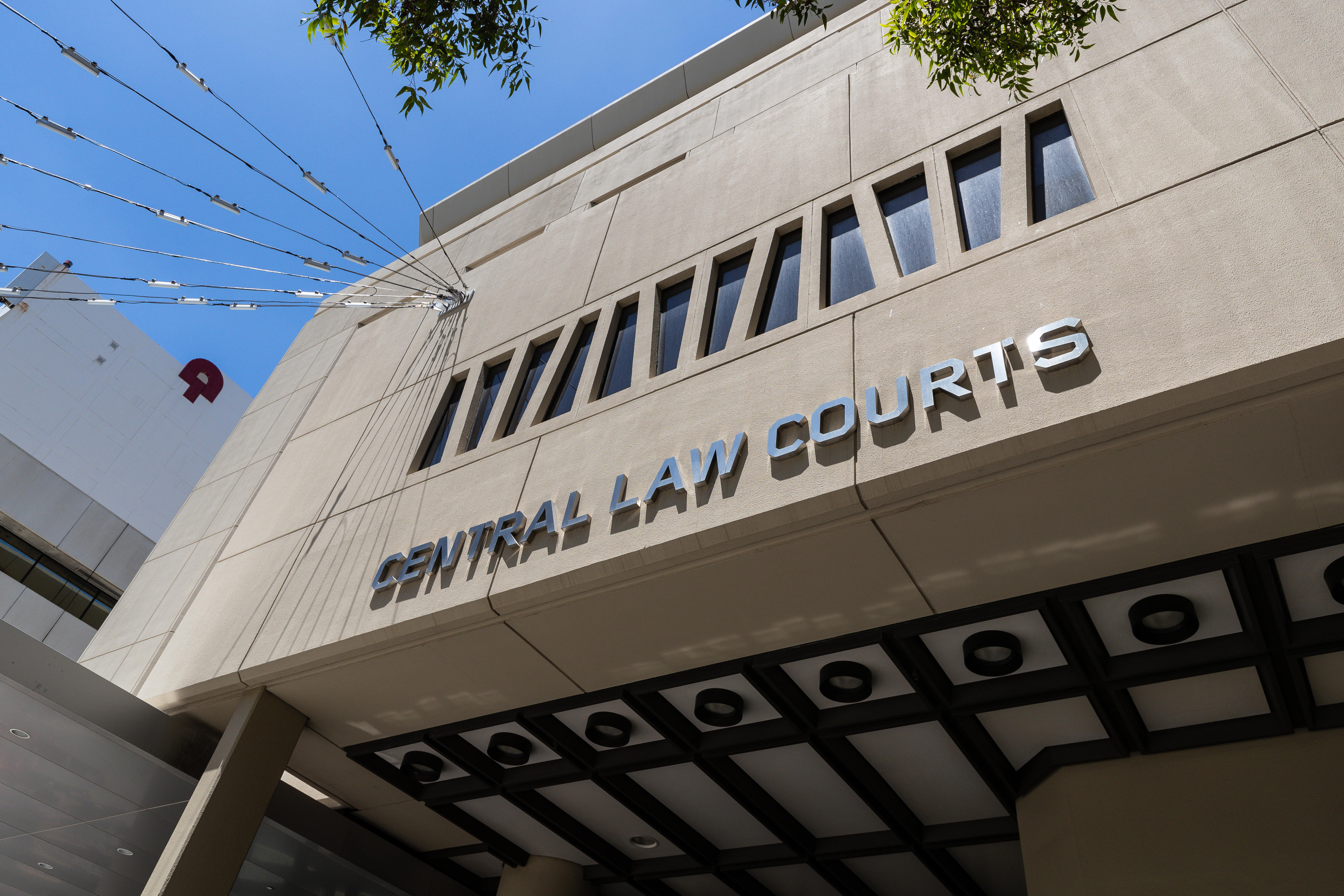 A shot of a grey building with the words 'central law courts' written on the side. 