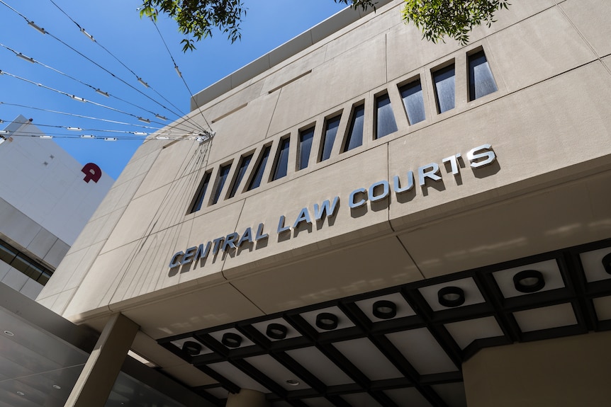 A shot of a grey building with the words 'central law courts' written on the side. 