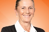 A smiling woman against an orange background.