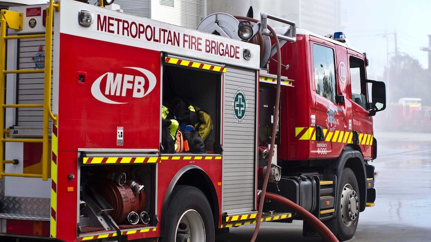 A parked MFB fire truck, with its hoses out.