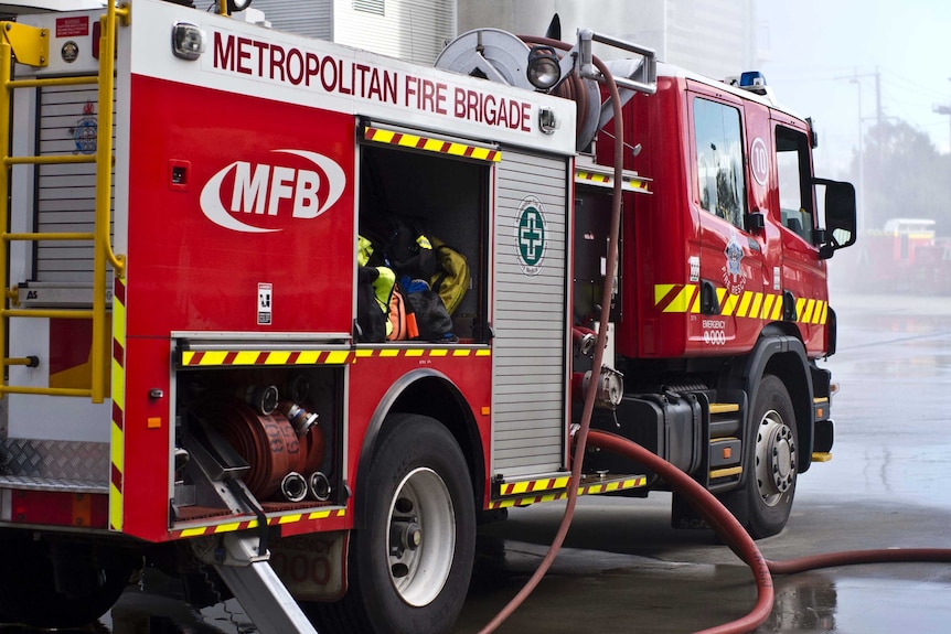 Parked MFB fire truck with hoses out.