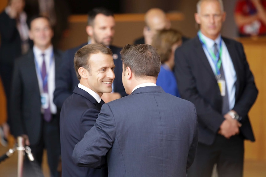French President Emmanuel Macron speaks with Luxembourg's Prime Minister Xavier Bettel