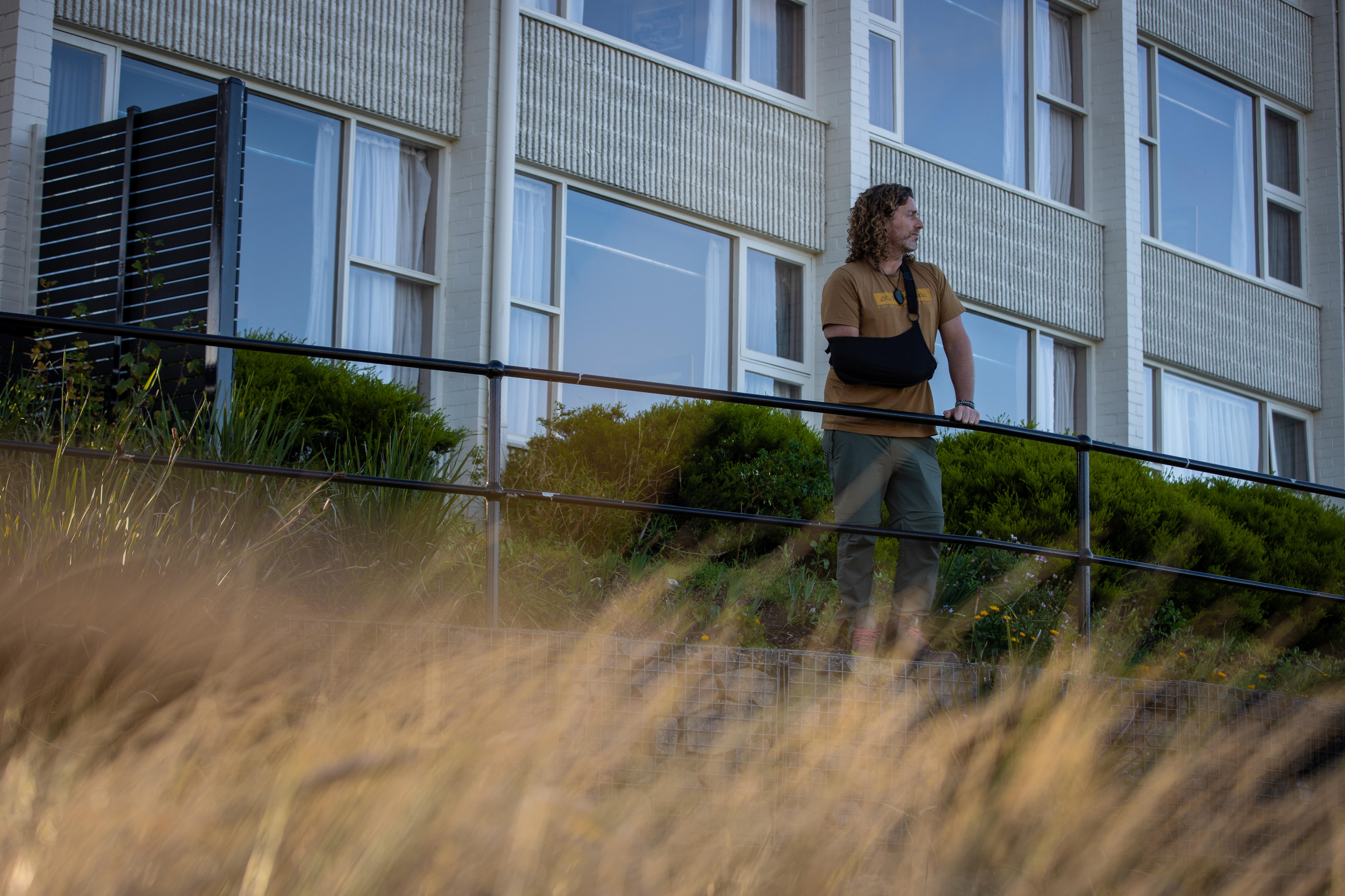 Gavin Tunstall, with his arm in a sling, looks into the distance.