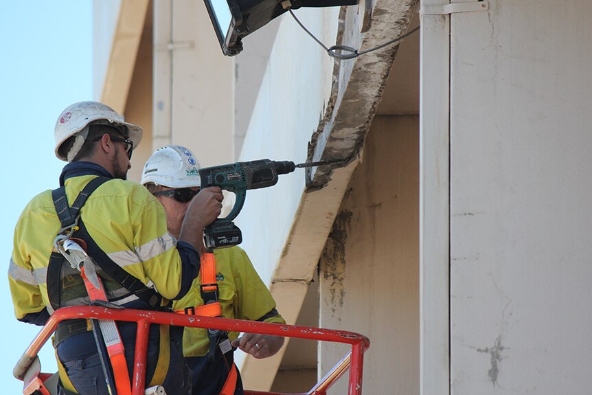 Workers inspect the Toowoomba SES HQ from a crane