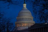 The US Capitol building illuminated at dusk
