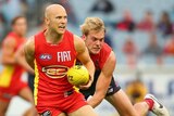 Ablett tries to beat the tackle of Watts