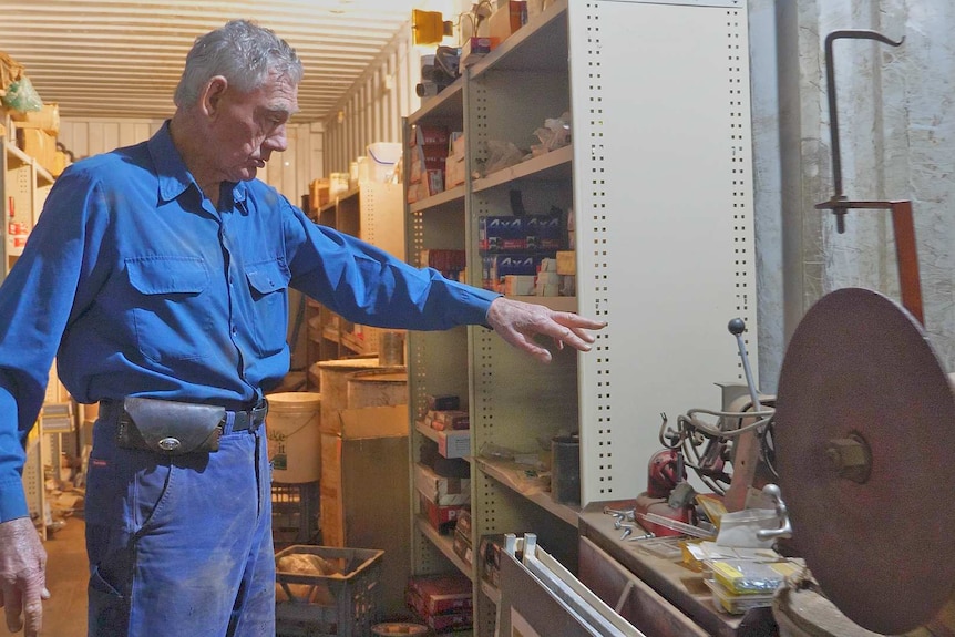 A man stands in a mechanical workshop