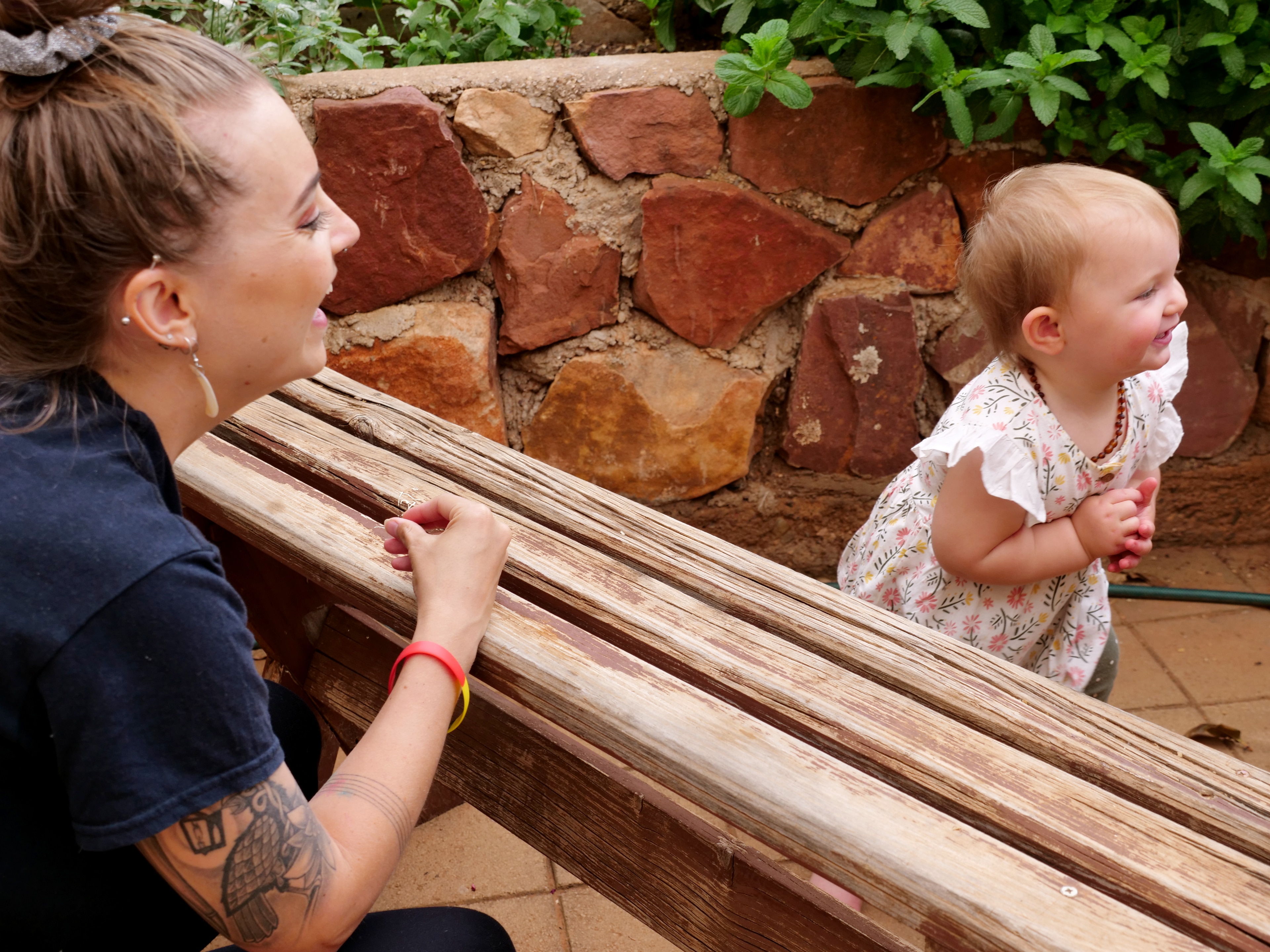 a woman laughing playing with a child