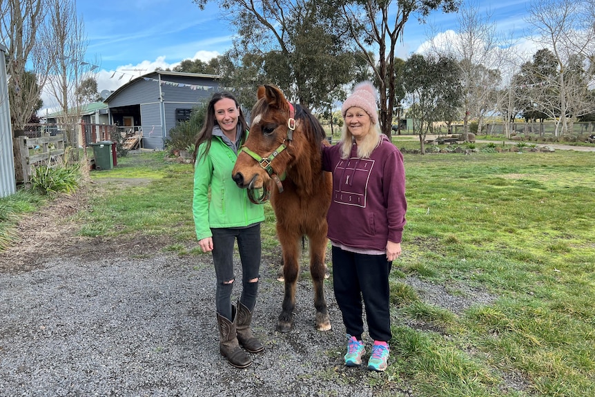 two women with a horse.