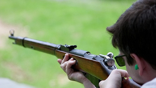 Man shooting rifle at shooting range