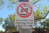 A sign ruling out consumption of alcohol on tree in Halls Creek