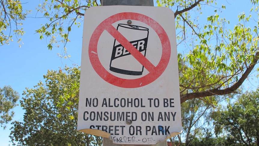 A sign ruling out consumption of alcohol on tree in Halls Creek