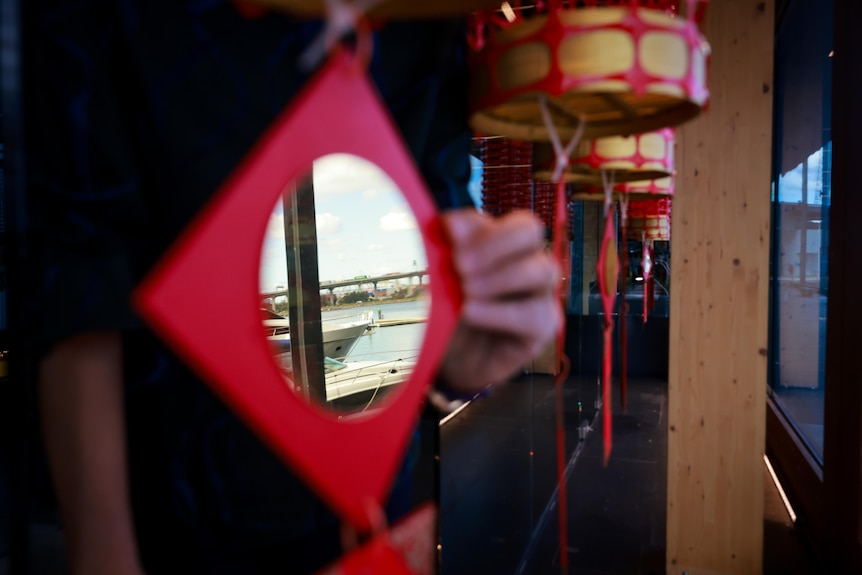 Reflection of a boat and the water can be seen from the mirror on Jenny's art installation. 