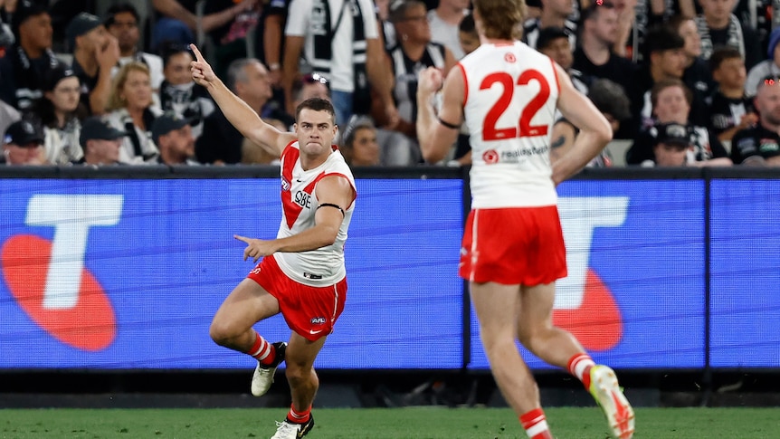 A Sydney Swans player runs away from goal in celebration at the MCG.